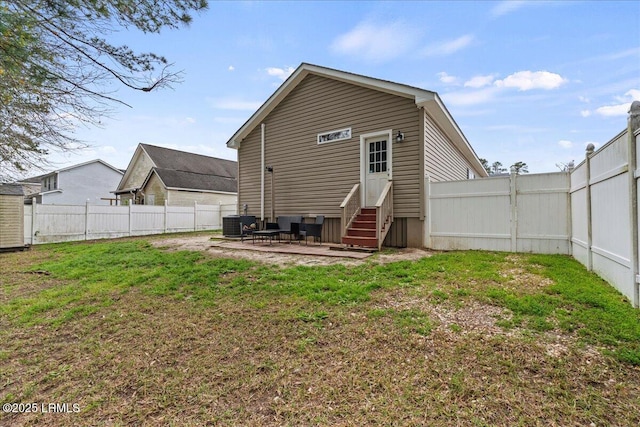 rear view of property with a lawn, a fenced backyard, entry steps, and a patio area
