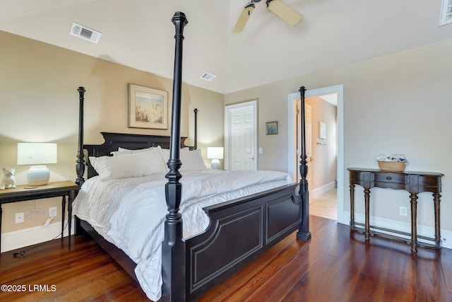 bedroom with lofted ceiling, baseboards, visible vents, and wood finished floors