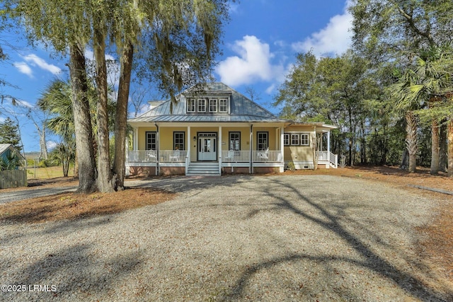 country-style home with a porch, a standing seam roof, and metal roof