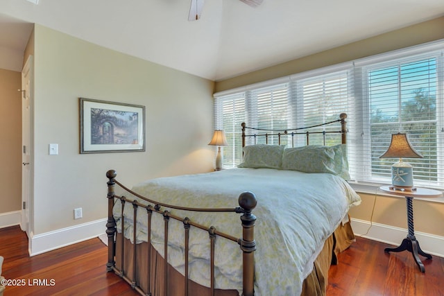 bedroom featuring ceiling fan, baseboards, and wood finished floors