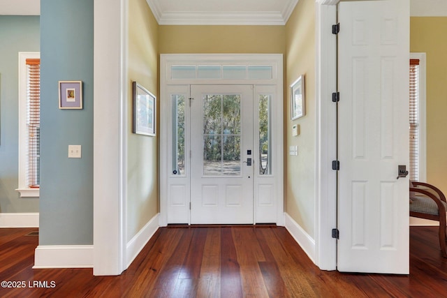 entrance foyer featuring ornamental molding, dark wood-style flooring, and baseboards