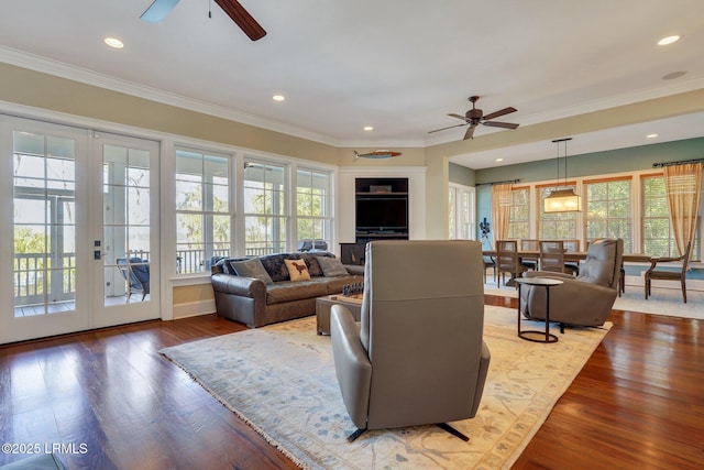 living room with french doors, wood finished floors, a ceiling fan, and crown molding