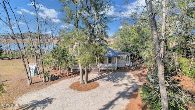 view of front facade featuring a porch and gravel driveway