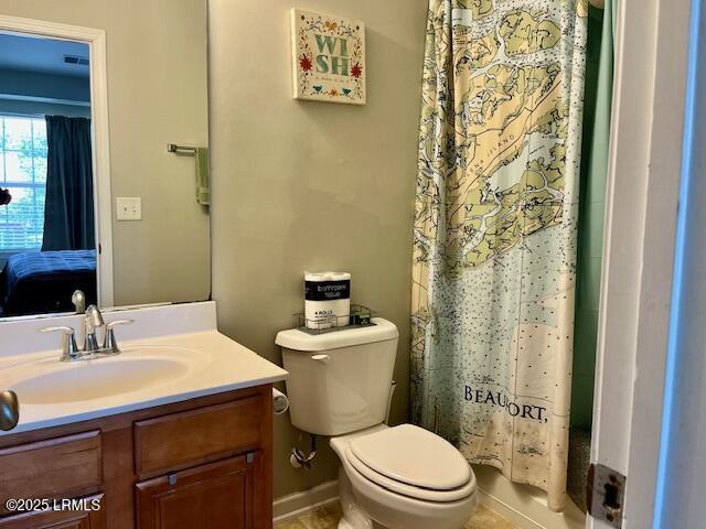 522 Candida Dr, Beaufort, SC 29906 - bathroom with toilet, vanity, curtained shower, and ensuite bath