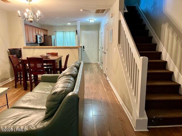 522 Candida Dr, Beaufort, SC 29906 - living area featuring hardwood / wood-style floors, stairs, a chandelier, and baseboards