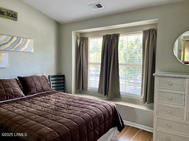 522 Candida Dr, Beaufort, SC 29906 - bedroom with multiple windows and wood finished floors
