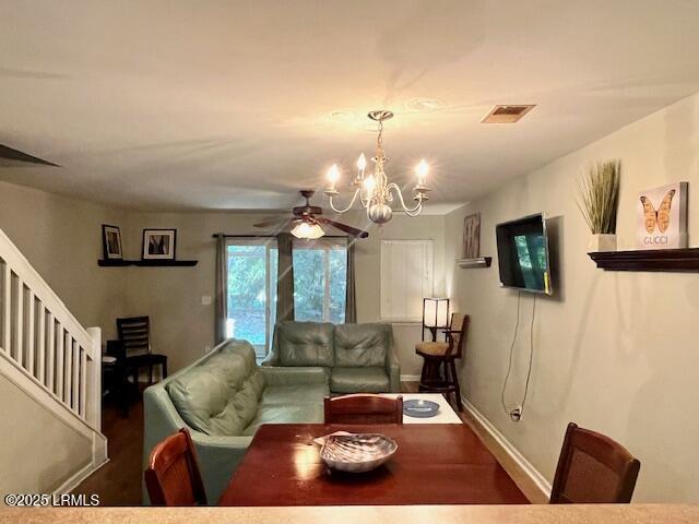 522 Candida Dr, Beaufort, SC 29906 - living room featuring stairway, a chandelier, ceiling fan, baseboards, and wood finished floors