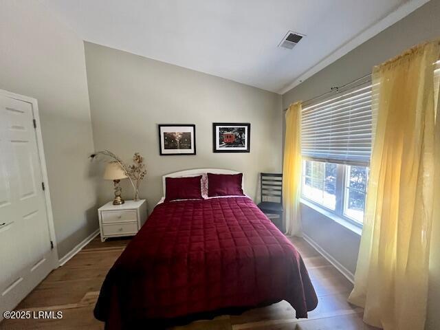 522 Candida Dr, Beaufort, SC 29906 - bedroom with lofted ceiling, wood finished floors, and baseboards