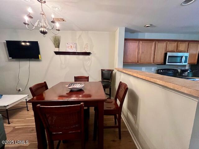 522 Candida Dr, Beaufort, SC 29906 - dining room featuring a chandelier, light wood-style floors, and baseboards