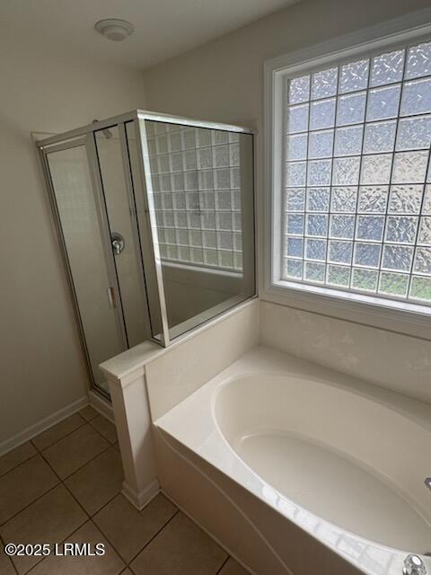 120 Crossings Blvd, Bluffton, SC 29910 - bathroom featuring tile patterned floors, a garden tub, a shower stall, and baseboards