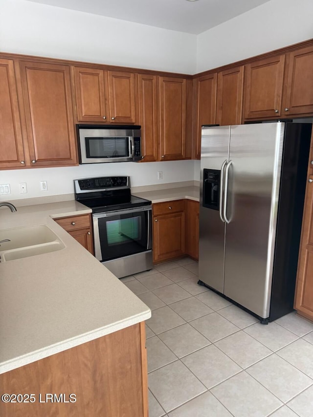 120 Crossings Blvd, Bluffton, SC 29910 - kitchen with appliances with stainless steel finishes, a sink, and brown cabinetry
