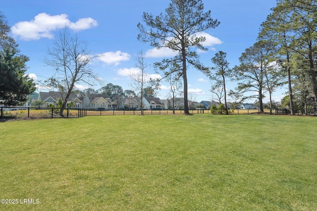 view of yard with fence and a residential view