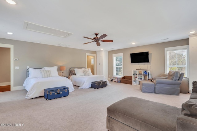 bedroom featuring attic access, multiple windows, and carpet flooring