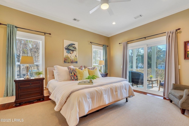 bedroom with access to outside, visible vents, crown molding, and wood finished floors