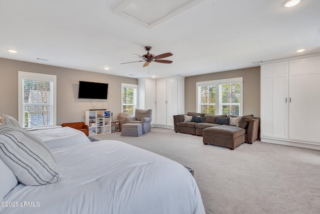 bedroom with light carpet, multiple windows, and recessed lighting