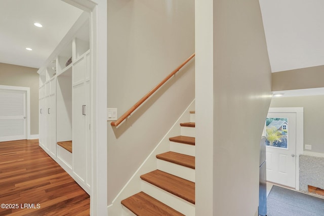 stairs featuring recessed lighting and wood finished floors