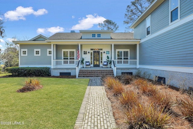 property entrance featuring a porch, a yard, and a shingled roof