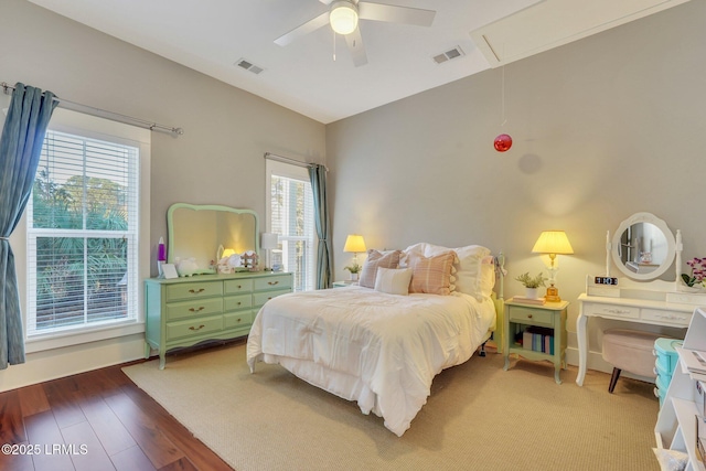 bedroom featuring multiple windows, visible vents, and attic access