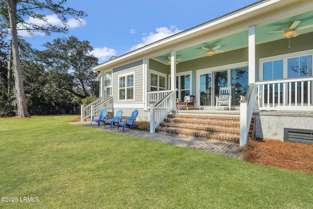 rear view of house with a ceiling fan, a yard, and a patio