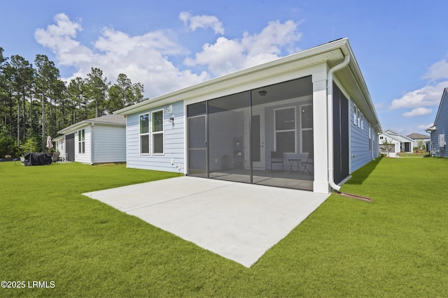 821 Aurora Way, Bluffton, SC 29909 - rear view of house featuring a sunroom, a patio area, and a lawn