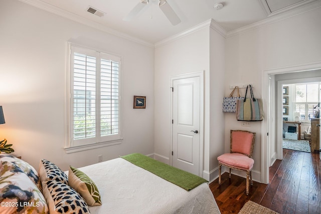 bedroom with dark hardwood / wood-style flooring, multiple windows, ornamental molding, and ceiling fan