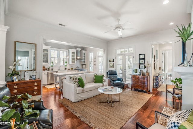 living room featuring dark hardwood / wood-style flooring, ornamental molding, and french doors