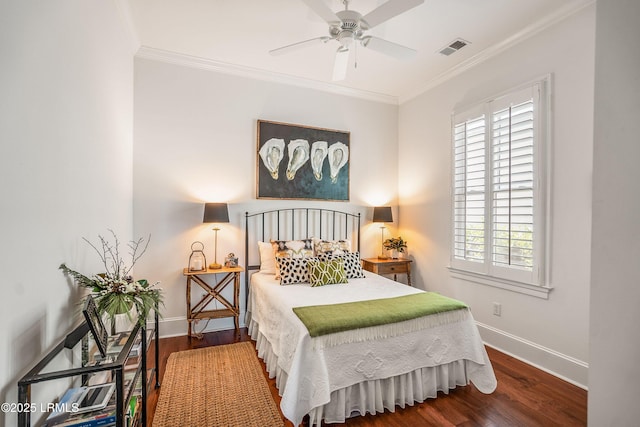 bedroom with ornamental molding, hardwood / wood-style floors, and ceiling fan