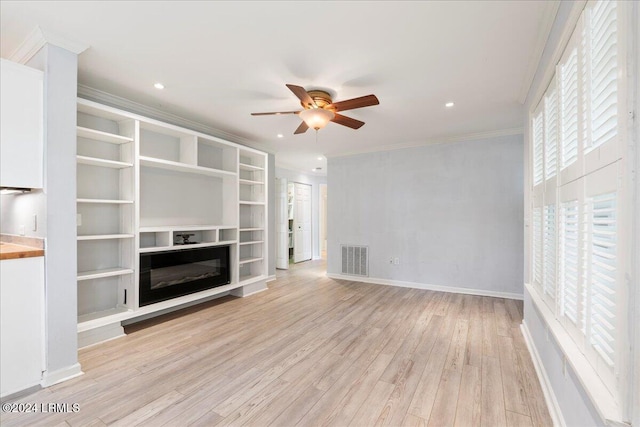 unfurnished living room featuring crown molding, ceiling fan, and light wood-type flooring