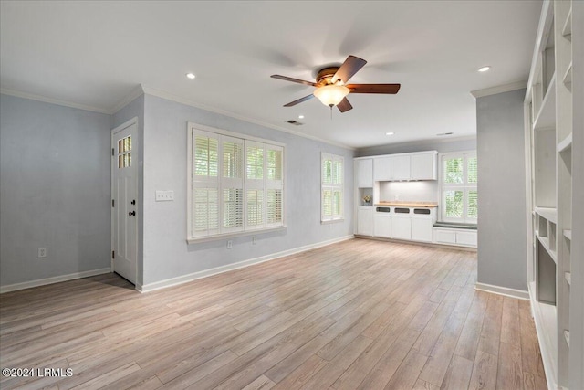 unfurnished living room featuring ceiling fan, ornamental molding, and light hardwood / wood-style floors