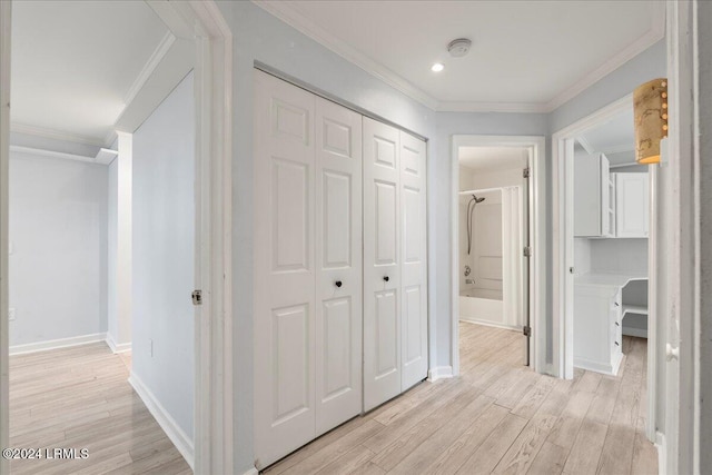 hall featuring ornamental molding and light hardwood / wood-style floors