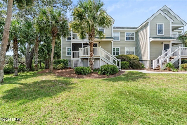 view of front of property with a front lawn and a sunroom