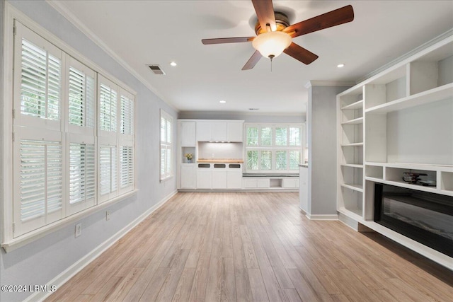 unfurnished living room featuring crown molding, ceiling fan, and light hardwood / wood-style flooring