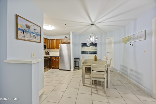 663 William Hilton Pkwy Unit 3410, Hilton Head Island, SC 29928 - dining area with baseboards, light tile patterned floors, and a notable chandelier