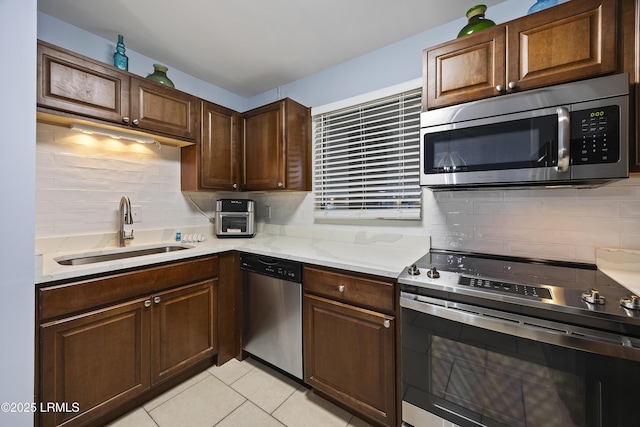 663 William Hilton Pkwy Unit 3410, Hilton Head Island, SC 29928 - kitchen featuring a sink, stainless steel appliances, decorative backsplash, light tile patterned floors, and light stone counters