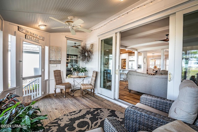 sunroom featuring ceiling fan