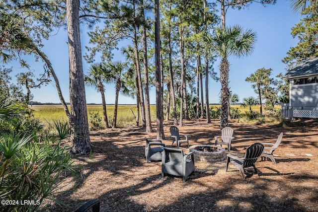 view of yard with a fire pit and a rural view