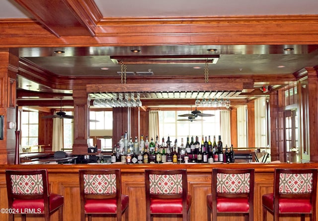 bar featuring ceiling fan and wood walls