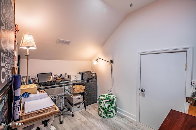 office with lofted ceiling and light wood-type flooring