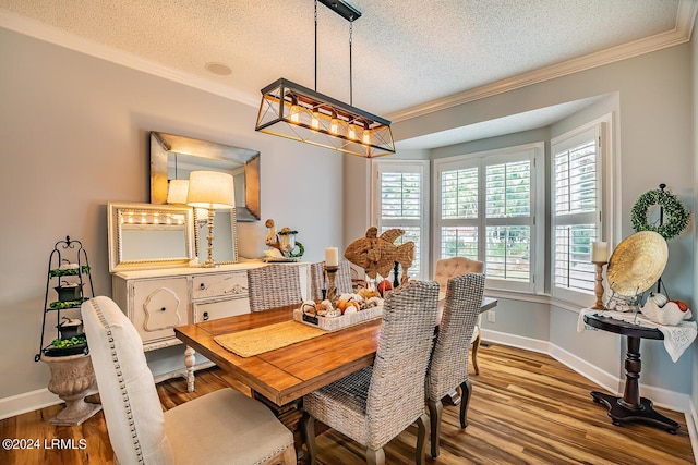 dining area with hardwood / wood-style flooring, crown molding, an inviting chandelier, and a textured ceiling