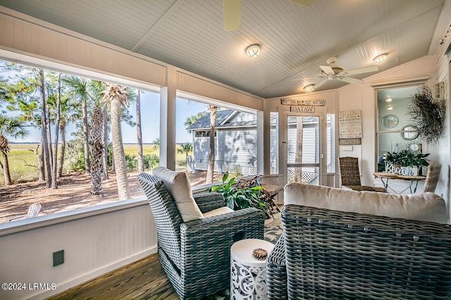 sunroom / solarium featuring lofted ceiling and ceiling fan