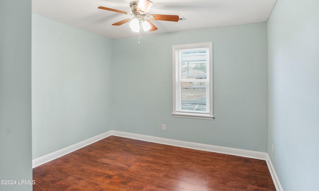 empty room featuring dark hardwood / wood-style floors and ceiling fan