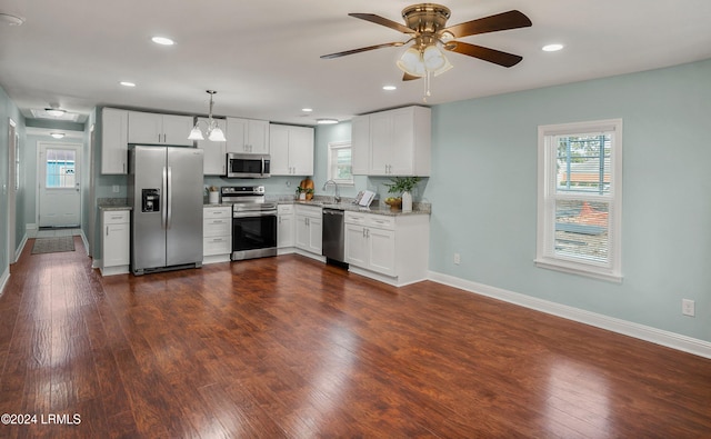 kitchen featuring white cabinetry, sink, pendant lighting, and stainless steel appliances