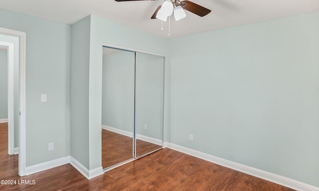 unfurnished bedroom featuring hardwood / wood-style flooring, a closet, and ceiling fan