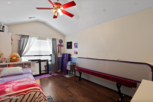 bedroom with visible vents, ceiling fan, wood finished floors, and vaulted ceiling
