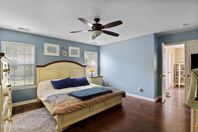 bedroom featuring baseboards, a ceiling fan, wood finished floors, and visible vents