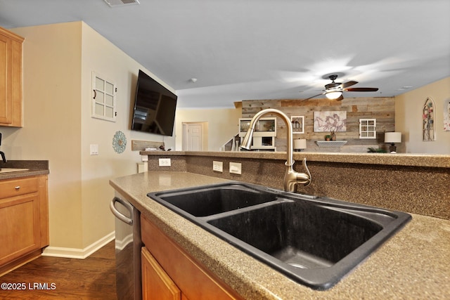 kitchen featuring a sink, ceiling fan, dark wood-style flooring, and open floor plan