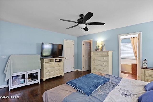 bedroom featuring baseboards, ensuite bath, wood finished floors, and ceiling fan