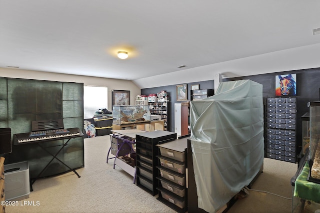 interior space featuring carpet flooring, visible vents, and vaulted ceiling