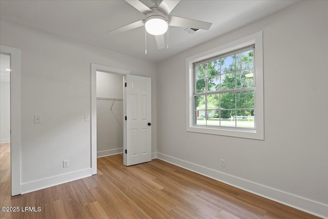 1807 Battery Park Dr, Port Royal, SC 29935 - unfurnished bedroom with light wood-style floors, a closet, a walk in closet, and ceiling fan