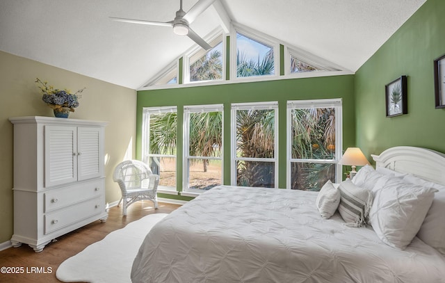 bedroom with a ceiling fan, lofted ceiling, baseboards, and wood finished floors